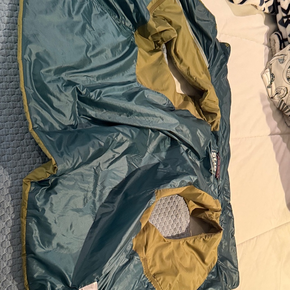 Stio Green Women's puff vest.  Interior is green and teal.  Zips and buttons.